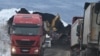 Kamioni natovareni ugljem odlaze, a drugi čekaju utovar kod Medne pored Mrkonjić Grada, na području bh. entiteta Republika Srpska. Fotografija nastala između decembra 2022. godine i marta 2023.