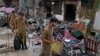 Police officers walk through the rubble of homes vandalized by a Muslim mob in a Christian area in Jaranwala, Faisalabad district, Pakistan, on August 17. 