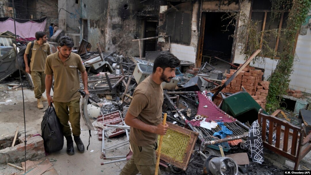 Police officers walk through the rubble of homes vandalized by a Muslim mob in a Christian area in Jaranwala, Faisalabad district, Pakistan, on August 17. 