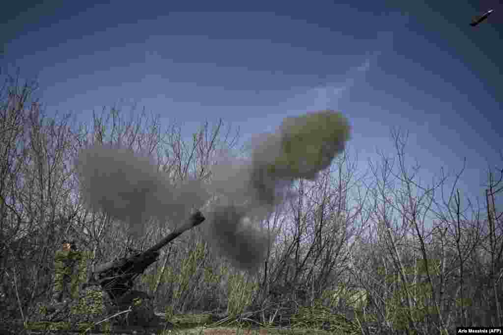 A Ukrainian M119 105-mm howitzer fires at Russian positions.