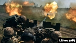 Ukrainian soldiers fire a cannon near Bakhmut in the Donetsk region on May 15.