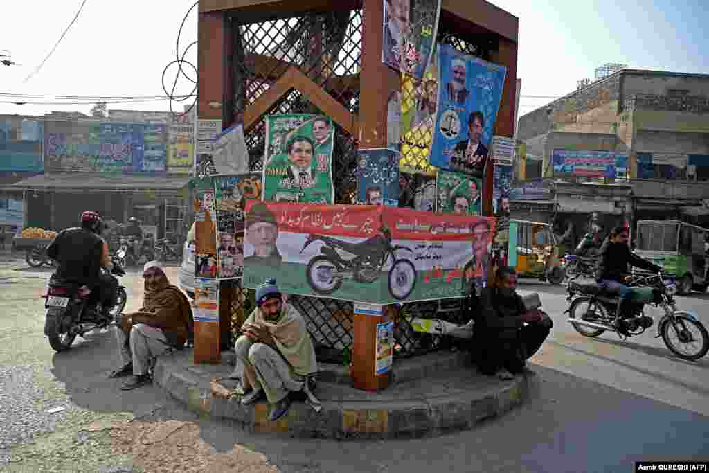 Motorcyclists ride past election campaign posters and banners ahead of upcoming general elections in Rawalpindi, Pakistan. Pakistan will vote in elections on February 8, with rights groups warning the ballot will lack credibility with popular opposition leader Imran Khan jailed and barred from contesting.