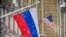 A Russian flag flies next to the U.S. Embassy building in Moscow.