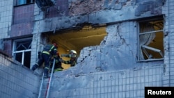 Rescuers work at the site of a building damaged during a Russian suicide drone strike in Kyiv on May 28.