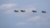 Russian-made MiG-29 fighter jets fly in formation over the Malacky Air Base in Slovakia in August 2022.