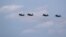 Russian-made MiG-29 fighter jets fly in formation over the Malacky Air Base in Slovakia in August 2022.