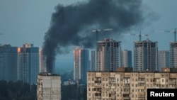 Smoke rises from a building in Kyiv following Russia's bombardment of the capital with missile and drone strikes on May 18.