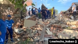 Emergency personnel work at the scene of the destroyed shopping center in Apsheronsk on July 22.