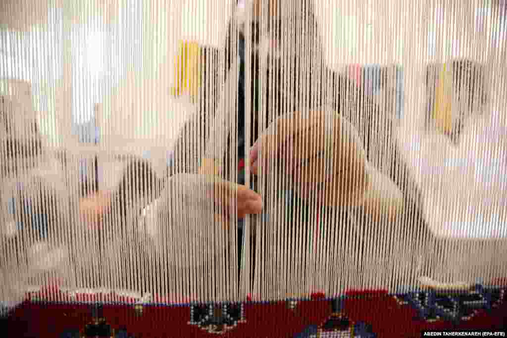 An Iranian woman crafts a handmade carpet in a weaving workshop in a house in Nushabad in Iran&#39;s central Kashan Province. Once a significant exporter, Iran&#39;s carpet industry has been impacted by sanctions over its nuclear program.