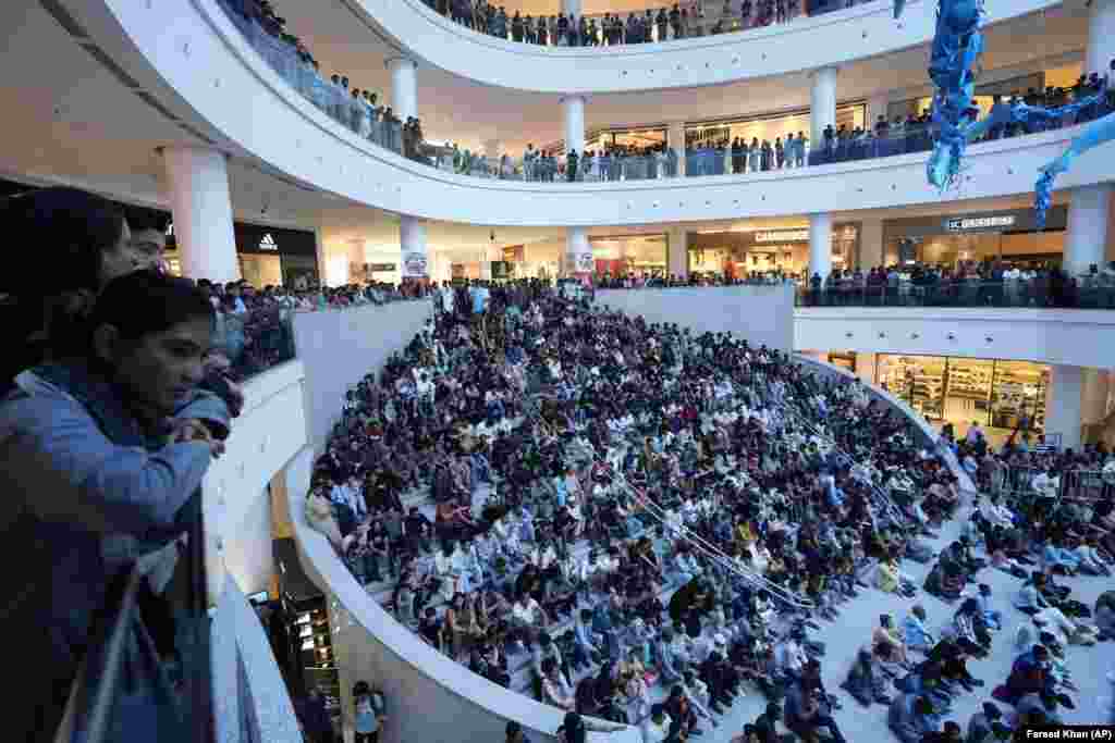 Pakistanis watch the Asia Cup cricket match being played in Colombo, Sri Lanka, between Pakistan and India on a big screen at a shopping mall in Karachi.