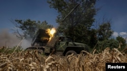 A Ukrainian soldier fires Grad missiles at Russian positions near Avdiyivka in eastern Ukraine. 