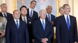 U.S. President Joe Biden (front center) and Hungarian Prime Minister Viktor Orban (back left) -- along with other European leaders -- attend a NATO event in Madrid in June 2022. Biden has excluded Orban from the list of invitees to his Summit for Democracy twice: in 2021 and this week.