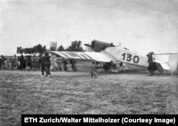 Locals pull Mittelholzer’s plane into position at an airfield in Persia.