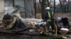 A firefighter extinguishes the remains of an unidentified missile that Kyiv claims was made in North Korea at the site of a Russian strike in Kharkiv on January 2.