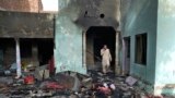 A Christian man looks through the debris of a home vandalized in the town of Jaranwala outside the eastern Pakistani city of Faisalabad on August 17 after it was ransacked by an angry mob.
