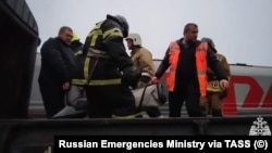 Rescue team work to evacuate passengers from the Vorkuta-Novorossiisk train on June 26.