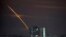 Rockets launched from Russia's Belgorod region streak across the sky at dawn in Kharkiv, Ukraine, early on March 24.