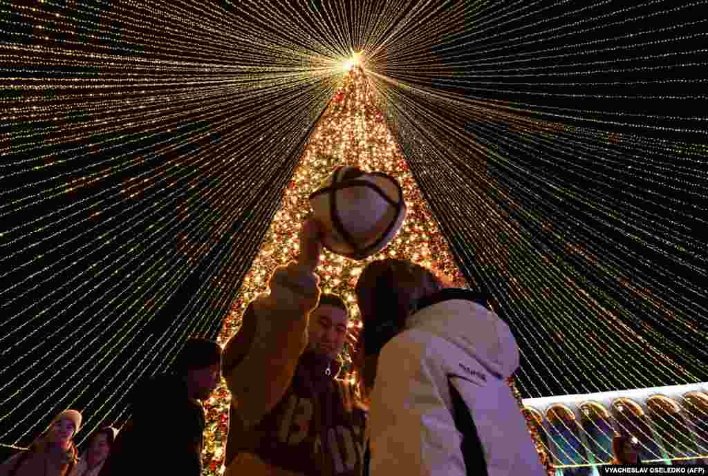 People enjoy festivities in the central Ala-Too Square, decorated to mark the upcoming New Year holiday, in Bishkek on December 20.