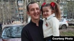 Damir Kalimulin, one of the 46 miners who died in the accident at the Kostenko mine, is seen with his daughter, who is now 7. “My daughter cries for her dad and this sadness has made her ill," says Kalimulin's widow, Yulya Kalimulina.
