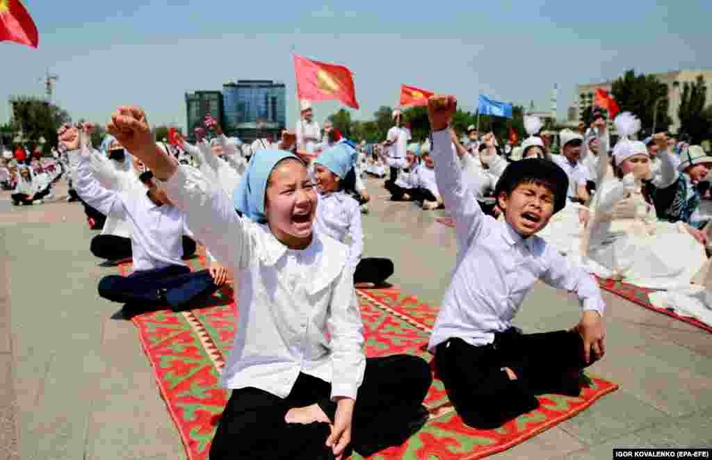 Kyrgyz schoolchildren recite the Manas epic on Victory Square in Bishkek.