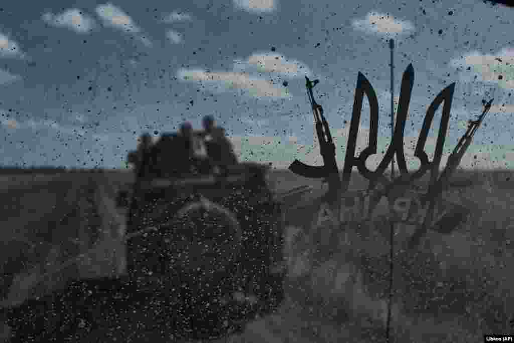 Ukrainian soldiers ride an armored personnel carrier at the front line near Bakhmut in the Donetsk region.&nbsp;