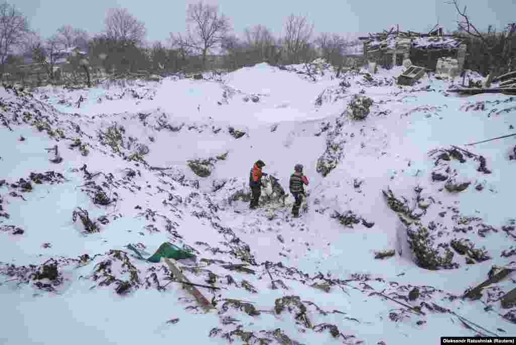 Rescuers with a dog work at the site of a Russian missile strike in the town of Pokrovsk in Ukraine&#39;s eastern Donetsk region.