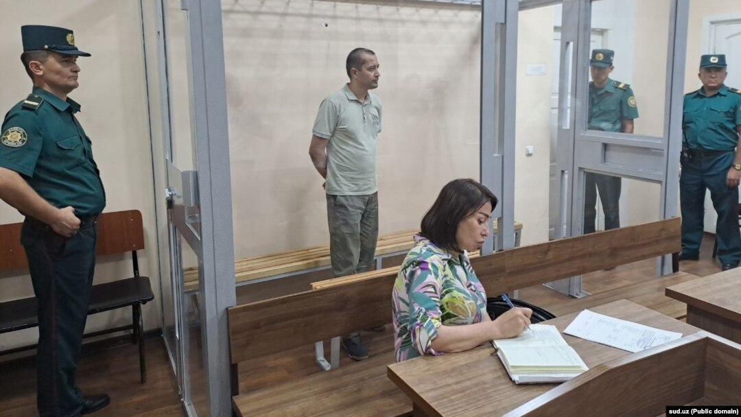 Abduqodir Muminov in the defendant's cage in a Tashkent courtroom in July
