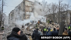 Українські рятувальники на місці ракетного обстрілу в Харкові, 23 січня 2024 року.