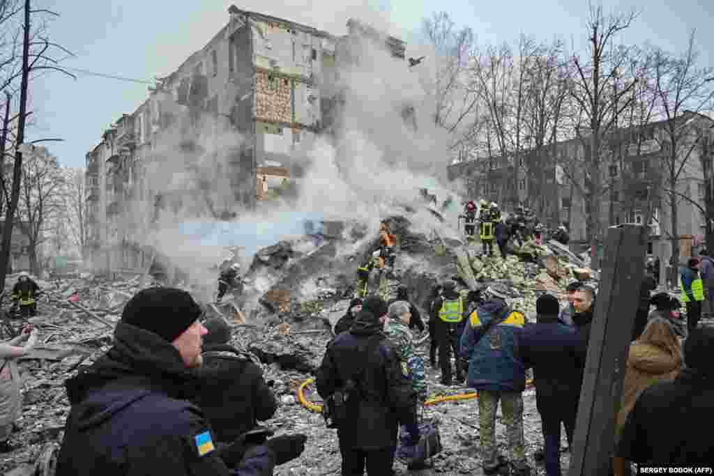 Ukrainian rescue and emergency workers work to clear the rubble throughout the morning. Syniehubov said Russia used S-300, Kh-32 and hypersonic Iskander missiles in the attack.