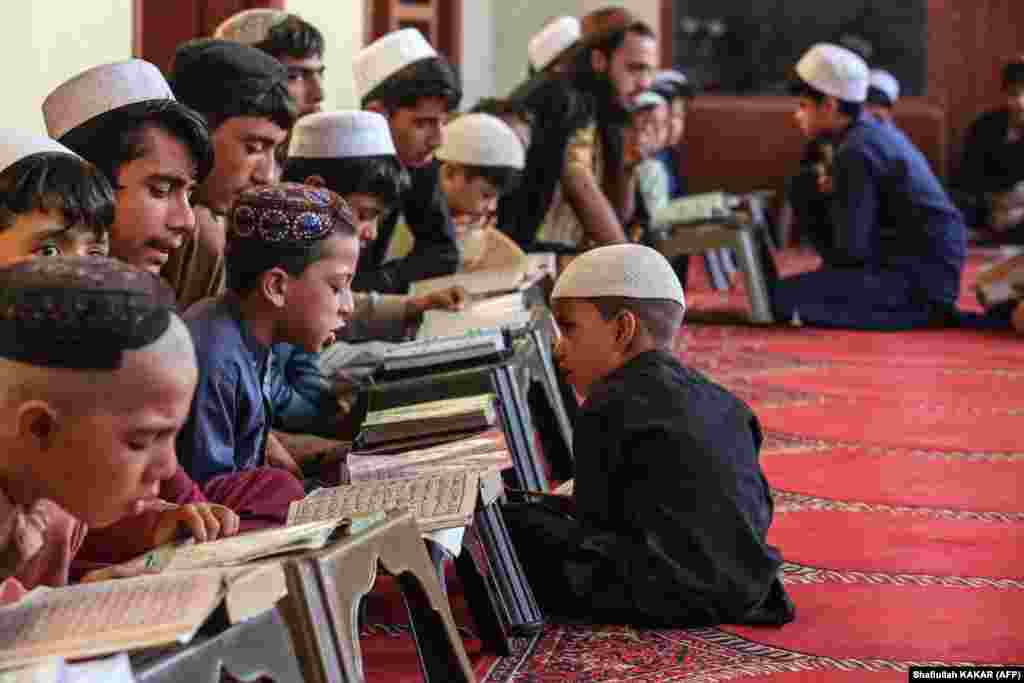 Afghan children read from the holy Koran at a madrasah, or Islamic school, in the Behsud district of Nangarhar Province.