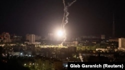 An explosion is seen in the sky over Kyiv during a Russian air strike early on May 16.