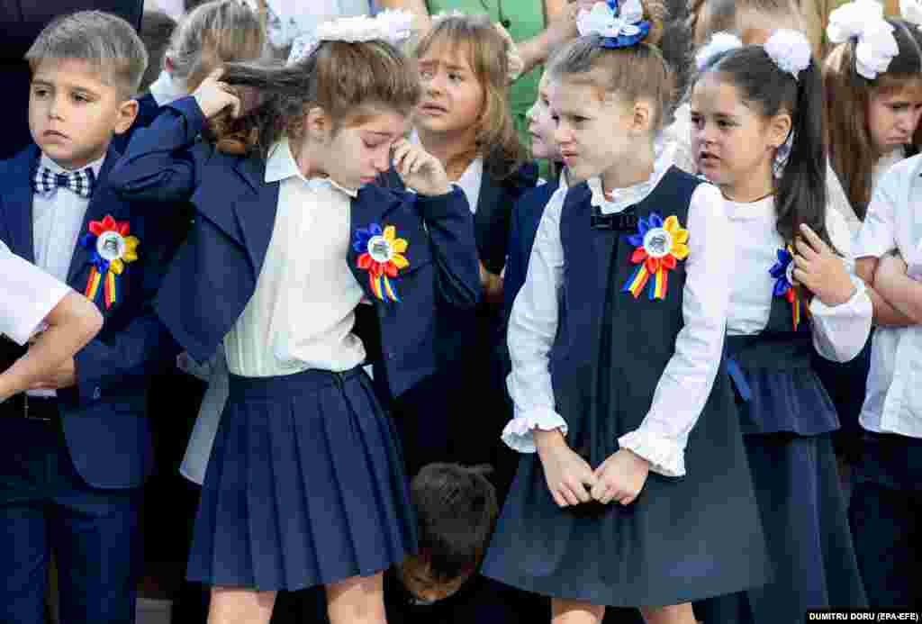 A little girl rubs her tired eyes during the first day at the lyceum named after Moldovan writer Gheorghe Asachi in Chisinau. &nbsp;