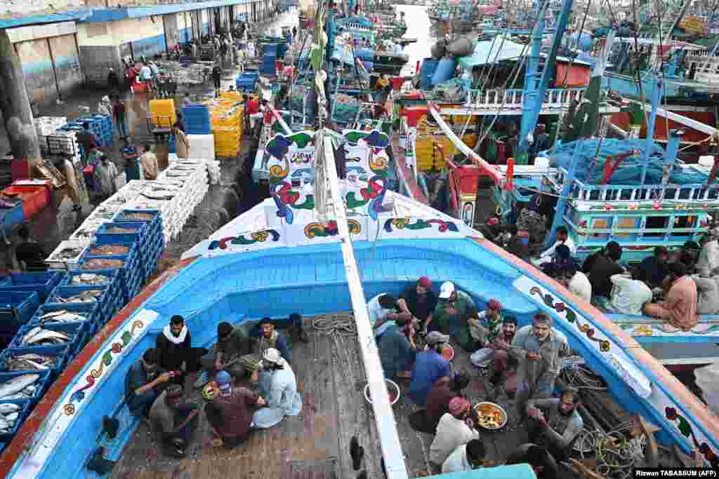 Pakistani fishermen break their Ramadan fast on the decks of fishing boats at a harbor in Karachi.