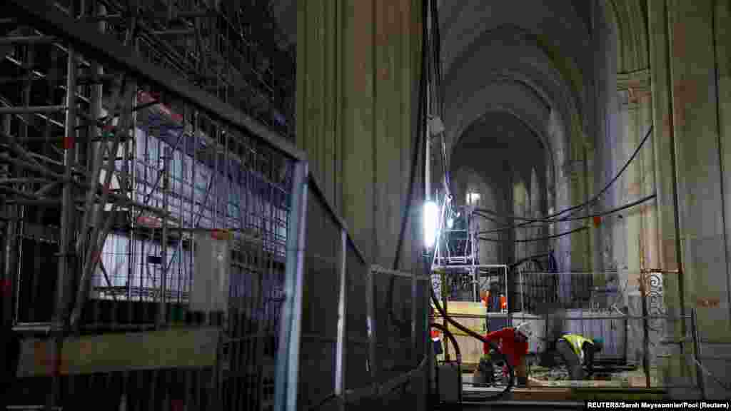 Munkások a Notre-Dame főhajójában, amelyet négy évvel ezelőtt tűzvész pusztított el.&nbsp;A Notre-Dame de Paris (Párizsi Miasszonyunk) katolikus székesegyház építését a XII. században kezdték el&nbsp;