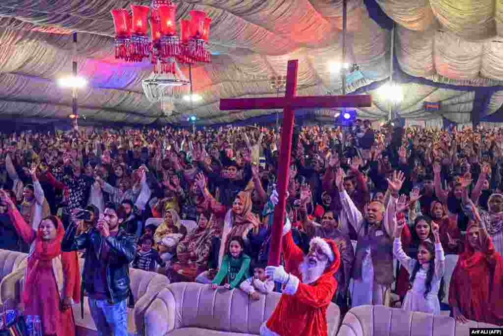 Christian devotees take part in a special Mass ahead of Christmas at a church in Lahore, Pakistan, on December 20.