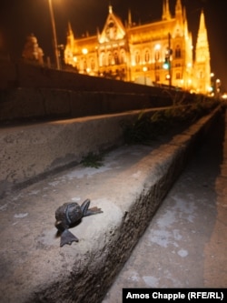 A frog-legged Soviet ushanka cap fixed onto steps near Hungary's parliament building