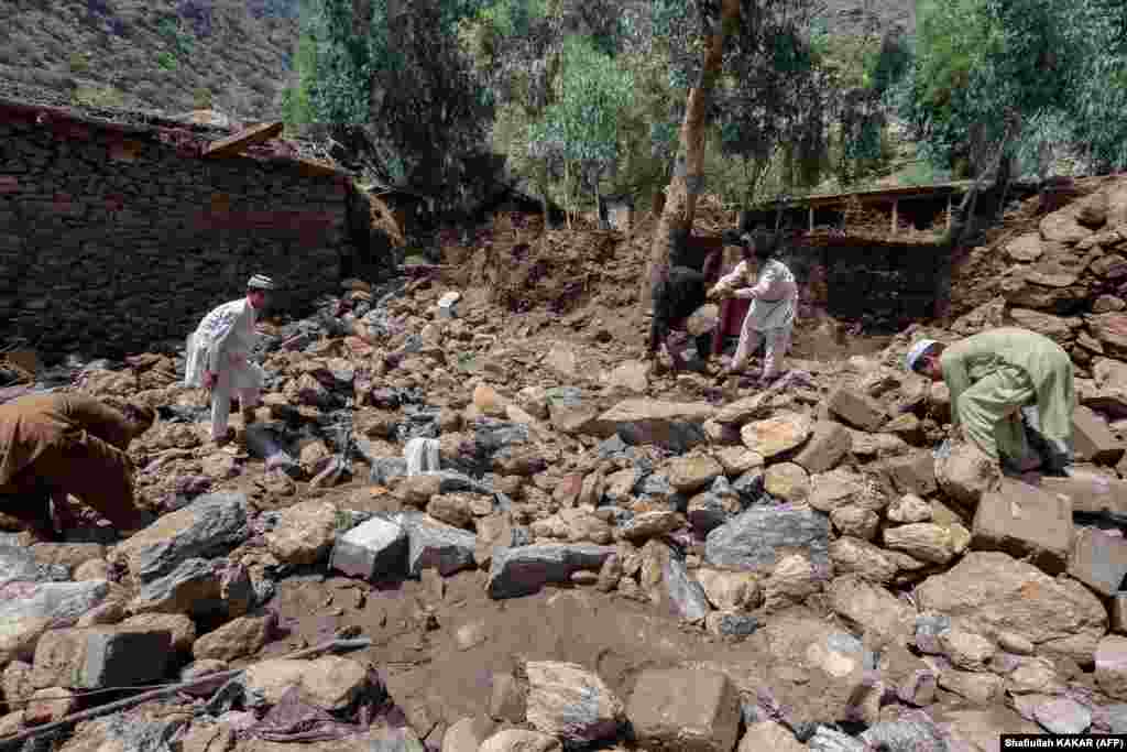 Villagers in the Watapur district of Kunar Province&nbsp;clear debris next to their homes.
