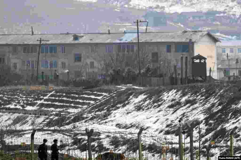 Između zahrđalih fabrika i redova stambenih blokova nazire se svakodnevica, dok Severnokorejci za život zarađuju vukući drvenu građu i paleći polja.