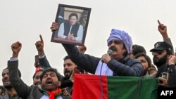 Ali Amin Gandapur, nominated to be chief minister of Khyber Pakhtunkhwa by the Pakistan Tehrik-e-Insaf (PTI) party, holds up a portrait of former Prime Minister Imran Khan at a protest in Peshawar on February 17. 