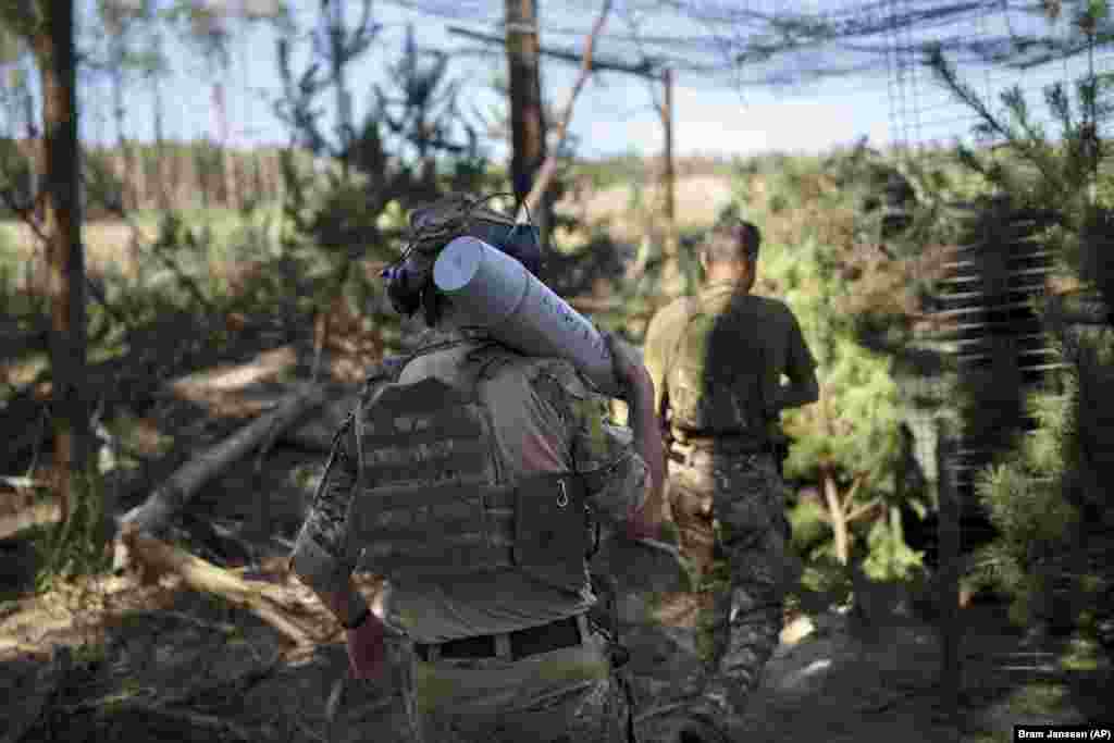 A Ukrainian soldier carries a shell with the message &ldquo;for Kharkiv&rdquo; toward a howitzer near Lyman, in Ukraine&rsquo;s Donetsk region in August 2023. Kharkiv has been under near constant attack from Russian forces since the 2022 invasion was launched. &ldquo;The probability that the enemy will read it is low. That&#39;s why they are photographed and posted on social networks.&rdquo; Rybakova says of customized projectiles. &ldquo;This is more of a message for Ukrainian society than for the enemy.&rdquo;