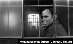 A boy on a cigarette break in a workshop of the Aszod juvenile detention center in 1974.