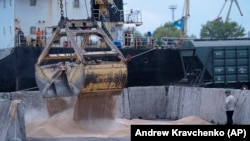 Workers load grain at a grain port in Izmayil, Ukraine, on April 26.