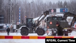 Vehicles of the Finnish Defense Forces are seen at the Vartius border station to provide assistance to the Border Guard to build a temporary barrier in Kuhmo, Finland, on November 19.
