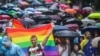 People brave the rain to attend the Pride Parade in Sofia on June 17.