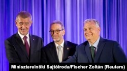 Prim-ministrul Viktor Orbán, președintele Fidesz, Herbert Kickl, președintele Partidului Libertății din Austria (FPÖ) și fostul prim-ministru ceh Andrej Babis, președintele partidului Acțiunea cetățenilor nemulțumiți (ANO), își strâng mâinile după parafarea înțelegerii.