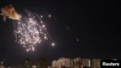 An explosion of a drone is seen in the sky over Kyiv during a Russian drone strike on September 10.
