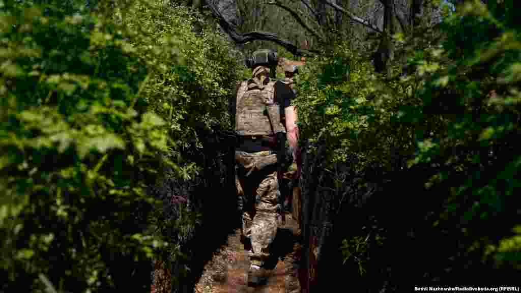 After a small break, a soldier returns to patrolling his trench position.