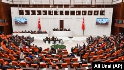 Turkish lawmakers follow the debate of Sweden's bid to join NATO at the Turkish Parliament in Ankara on January 23.