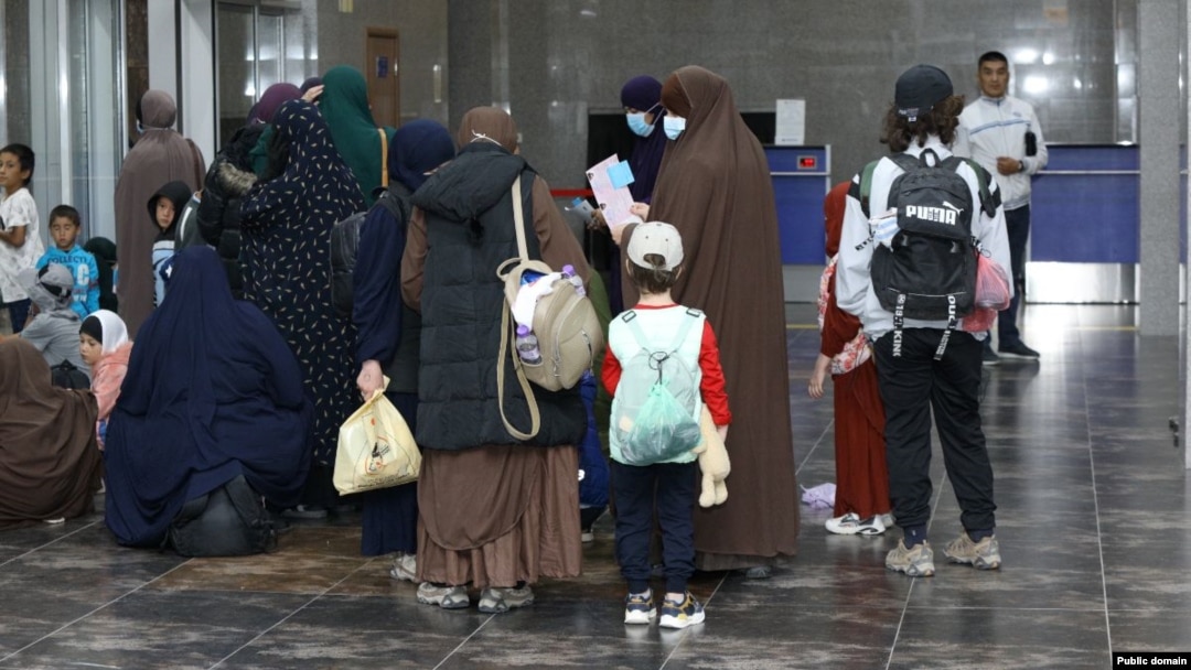 Kyrgyz women and children arrive in Bishkek from a Syrian refugee camp in August.