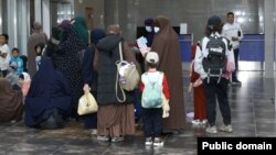 Kyrgyz women and children arrive in Bishkek from a Syrian refugee camp in August.